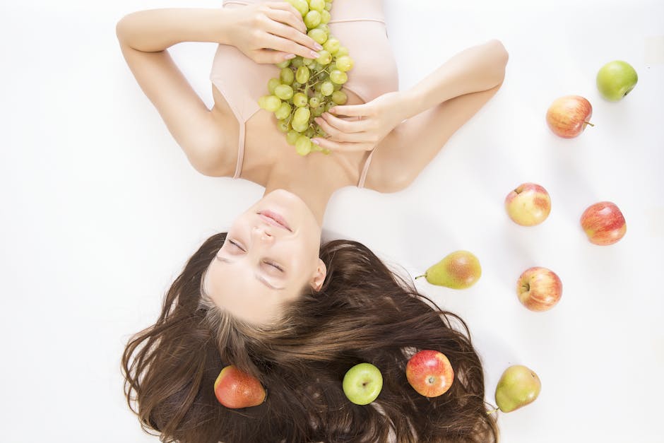Woman lying down with fresh fruits symbolizes beauty and wellness